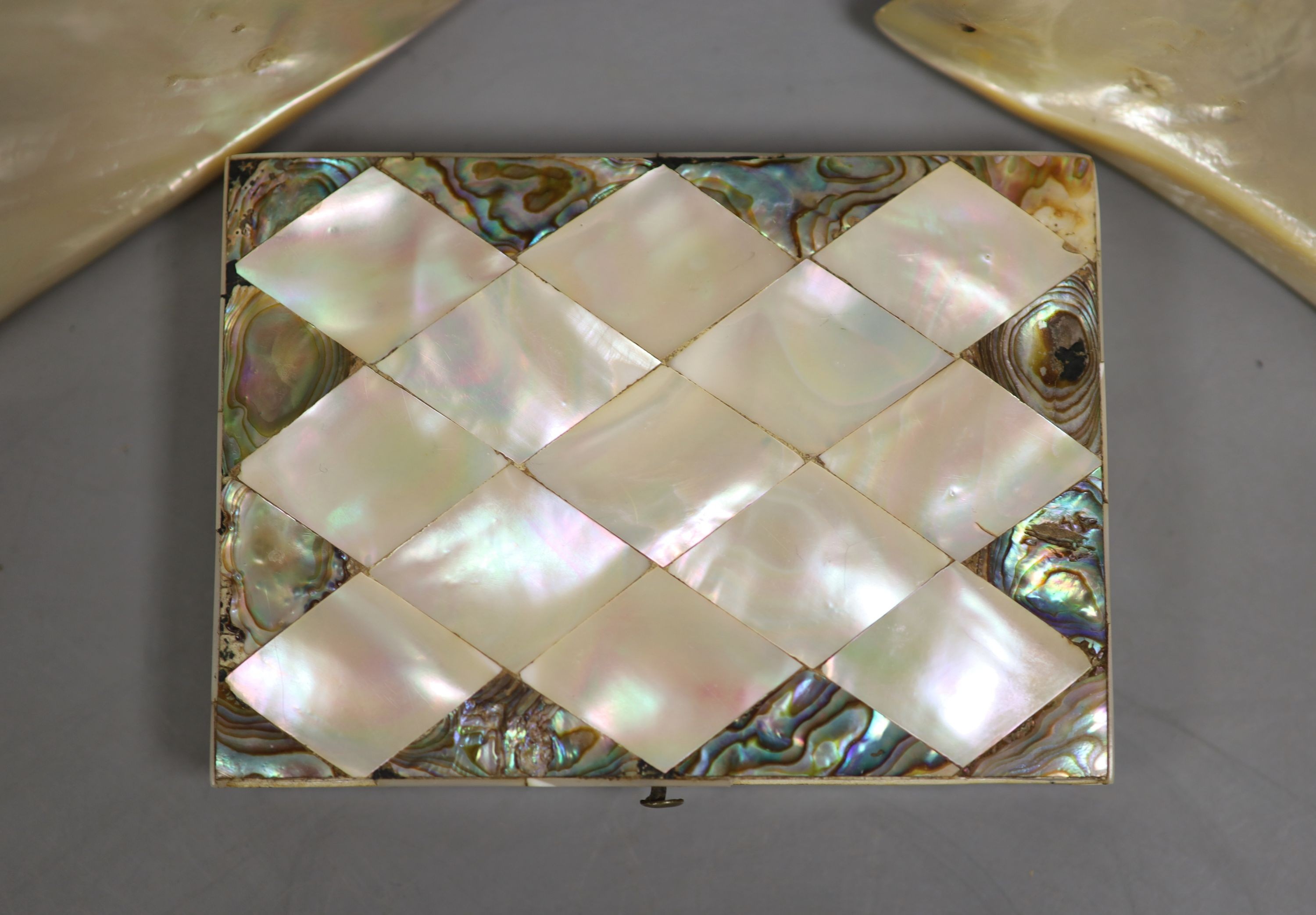 A mother of pearl purse and Chinese white metal decorated mother of pearl hinged shell